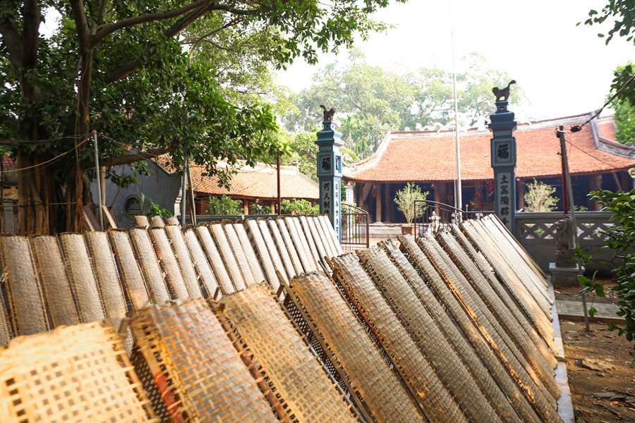 Traditional Tho Ha rice paper drying on bamboo mats